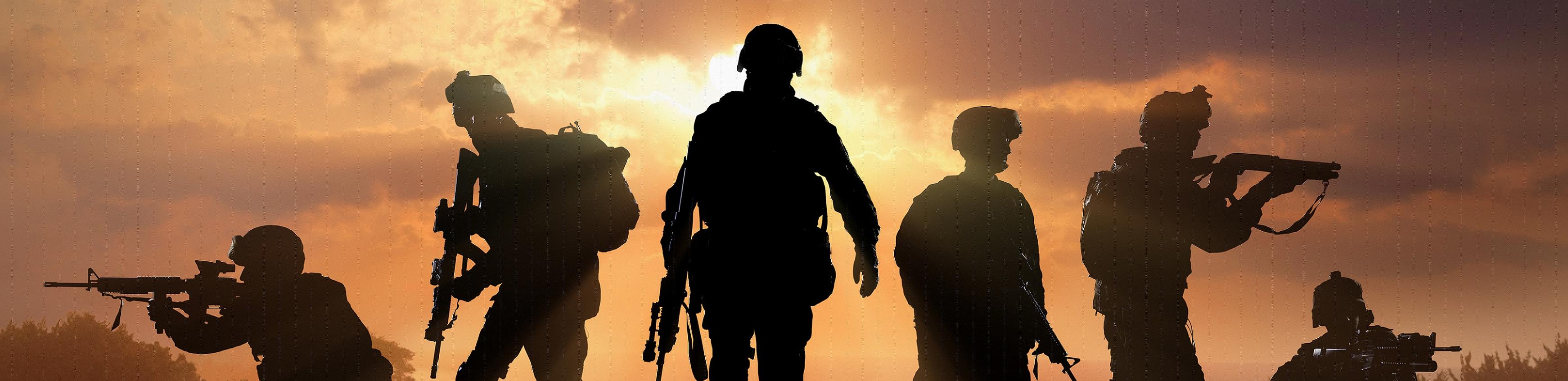 Six Military Silhouettes On Sunset Sky Stock Photo